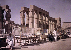 10455823
Egyptian market stalls outside a temple ruin, c 1920-1930.