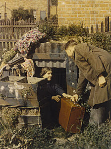 10462488
&copy; Royal Photographic Society
Man and woman with suitcase outside an Anderson shelter, 1939-1945.