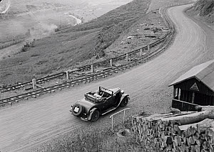 10547074
&copy; NMPFT - Zoltan Glass
Car on mountainous road that runs parallel to railway tracks. Photographed by Zoltan Glass, c.1930.