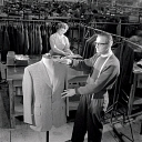 10414818
&copy; NMeM - Walter Nurnberg
A tailor makes final inspection of jacket, Burton Menswear, Leeds 1960