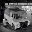 10414829
&copy; NMeM - Walter Nurnberg
A sign writer works on an Ilford films Austin van, Smith Motors, Goodmayes. England, 1960s.