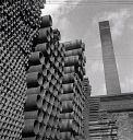 10414934
&copy; NMeM - Walter Nurnberg
Hundreds of finished steel tubes stacked in yard by chimney, 1948.