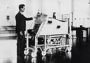 10250363
&copy; NMeM Daily Herald Archive
Professor Drinker with an iron lung, c 1928.