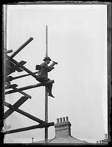 10462472
&copy; TBC / Royal Photographic Society
Horace Nicholls on a scaffold while taking a photograph, c.1903.