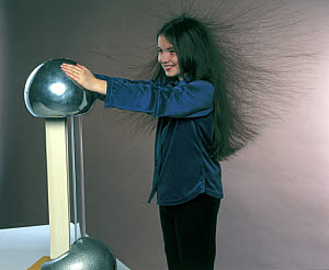 10314311
&copy; Science Museum
Girl holding a Van de Graaff generator, 1998.