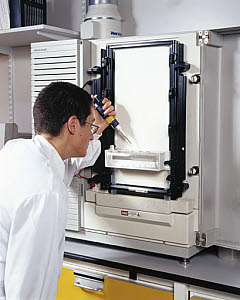 10322682
&copy; Science Museum
Molecular geneticist loading samples onto an automated DNA sequencer.