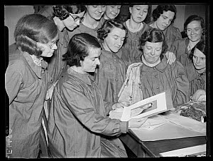 10448722
&copy; NMeM Daily Herald Archive
Girls admiring photograph of the Duchess of Kent, 30th December 1937.