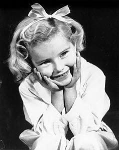 10327124
Little girl with a ribbon in her hair, c 1940s.