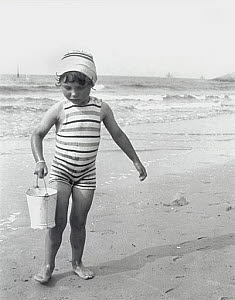 10309532
&copy; NMeM - Kodak Collection
Small girl carrying a bucket on the beach, 1910-1930.