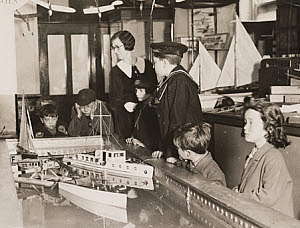 10468634
&copy; NMeM Daily Herald Archive
Boats on a miniature lake, Gamages Department Store, London, 1920s.