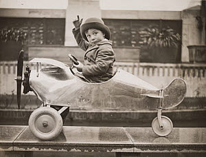 10468636
&copy; NMeM Daily Herald Archive
Boy sitting in a toy aeroplane, Selfridges, London, 18 December, 1931.