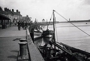 10309721
&copy; NMeM - Kodak Collection
Small fishing boats moored to a quayside, Whitby, North Yorkshire, c 1930s.