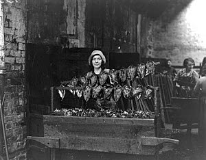 10317826
&copy; NMeM Daily Herald Archive
Kipper girl displaying smoked kippers, 24 September 1931.