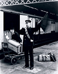 10306550
&copy; National Railway Museum
Guard signalling the departure of a LNWR train, London, 1907.