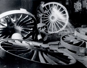 10308465
&copy; National Railway Museum
Burning off the 'runners' from driving wheel castings,1950.